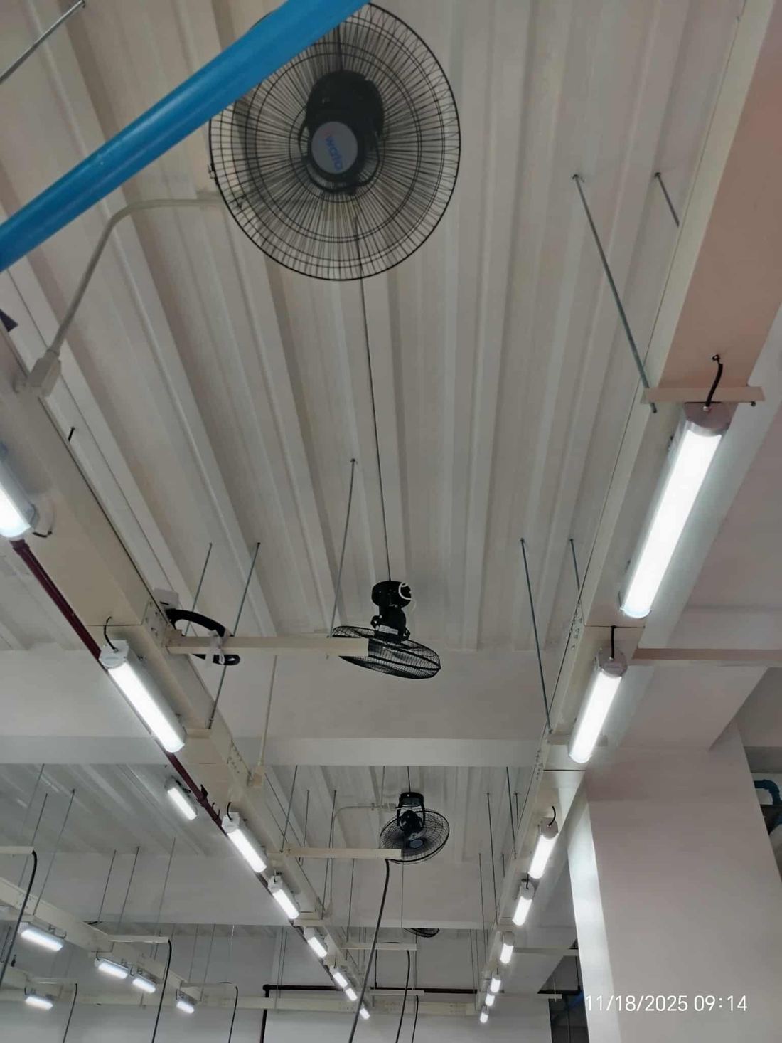 Factory lighting and ventilation fans installed