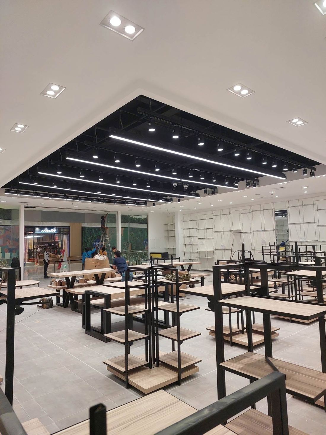 Retail store under construction with black ceiling grid